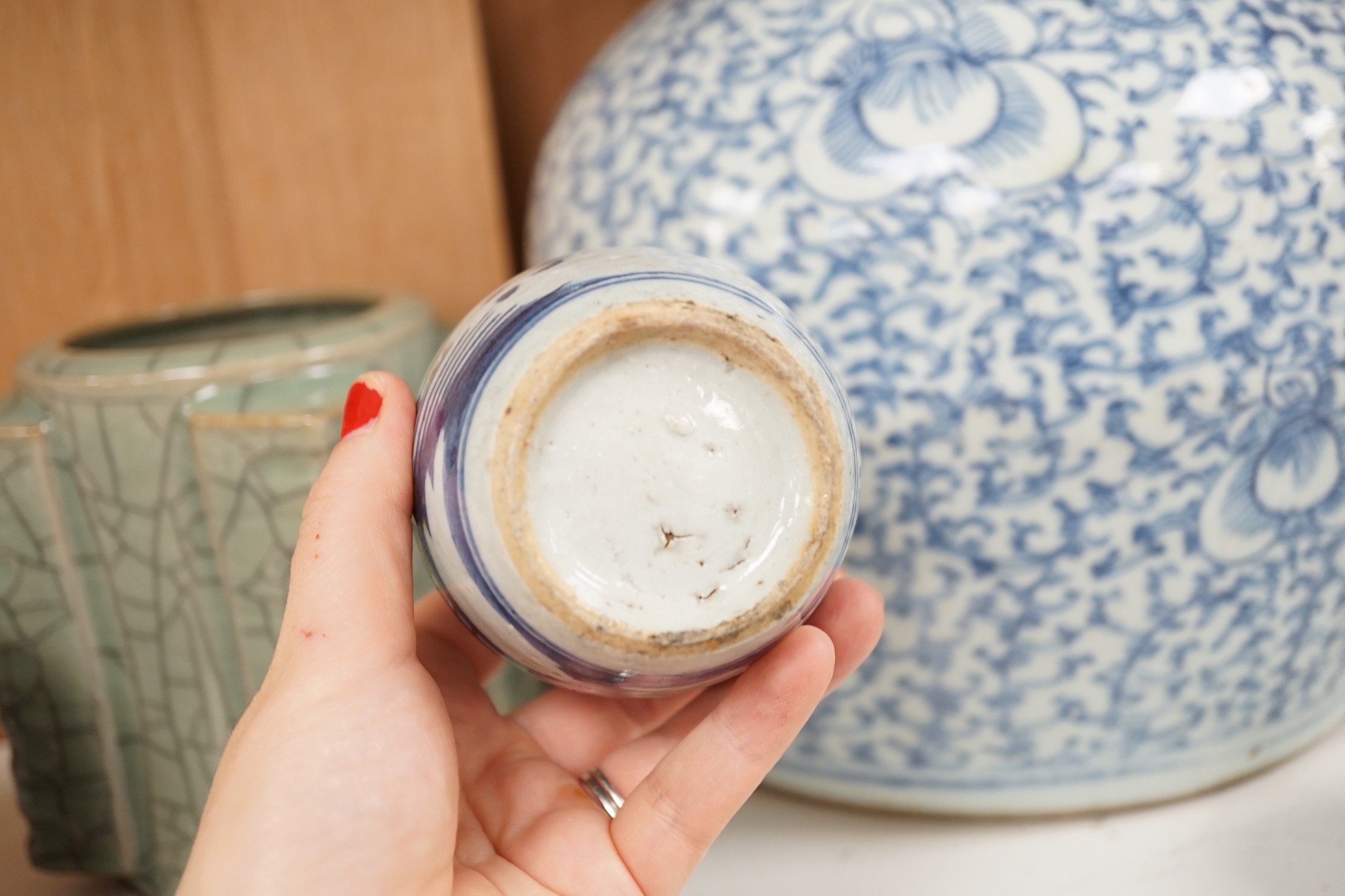 A group of 19th century blue and white jars, a stacking food box and two bowls, together with a celadon glazed cong vase and a soapstone figure of Liu Hai. Tallest 24cm